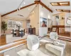 Living room with a skylights, vaulted ceiling and light hardwood flooring