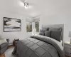 Bedroom featuring baseboard heating and hardwood / wood-style floors