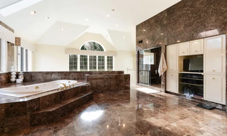 Primary Bathroom with High Ceiling and Skylights