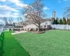 View of pool with an outdoor fireplace and a patio