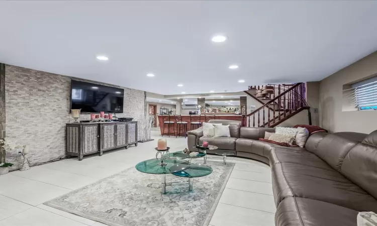 Living room featuring an AC wall unit and wood-type flooring