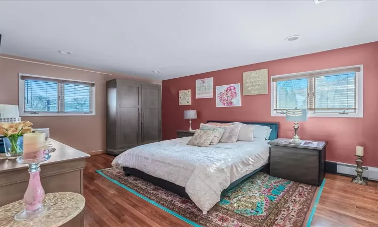 Bedroom with hardwood / wood-style flooring