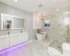 Full bathroom featuring separate shower and tub, vanity, a notable chandelier, and toilet