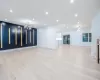 Unfurnished living room with a notable chandelier and light hardwood / wood-style flooring