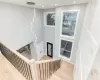 Stairway featuring hardwood / wood-style flooring