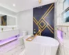 Bathroom featuring a tub to relax in, vanity, and toilet