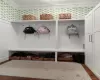 Mudroom with dark hardwood / wood-style flooring and ornamental molding