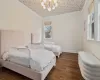 Bedroom featuring ornamental molding, a chandelier, and dark hardwood / wood-style floors