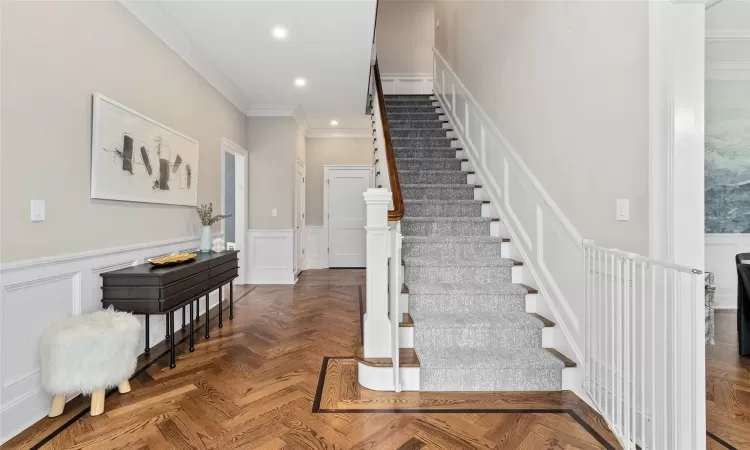 Stairs featuring parquet flooring and crown molding