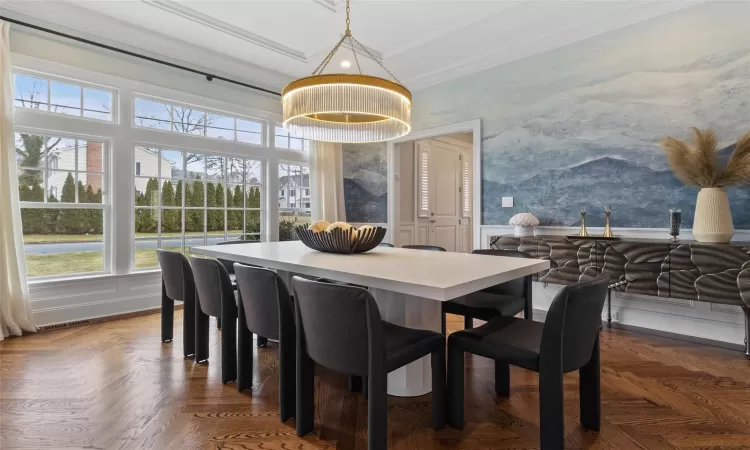 Dining room with crown molding and dark parquet floors