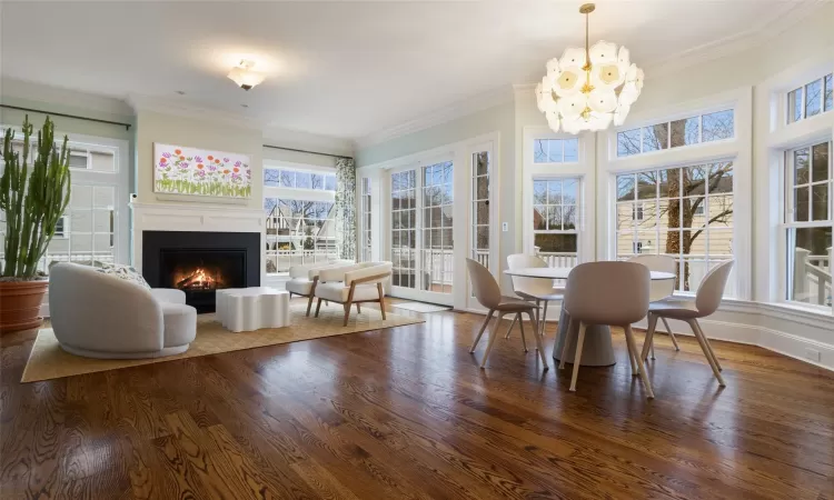 Sunroom with a wealth of natural light and an inviting chandelier