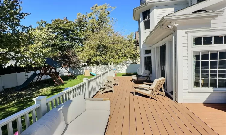 Wooden deck with a playground and outdoor lounge area