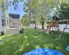 View of yard featuring a playground and a deck