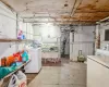 Basement with refrigerator and washing machine and clothes dryer