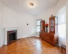 Unfurnished living room featuring light parquet floors and radiator