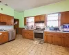 Kitchen with tasteful backsplash, sink, stainless steel appliances, and ornamental molding