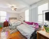 Bedroom featuring ceiling fan and parquet flooring