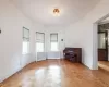 Empty room featuring radiator and dark hardwood / wood-style floors