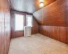 Bonus room featuring vaulted ceiling, wood ceiling, and wooden walls