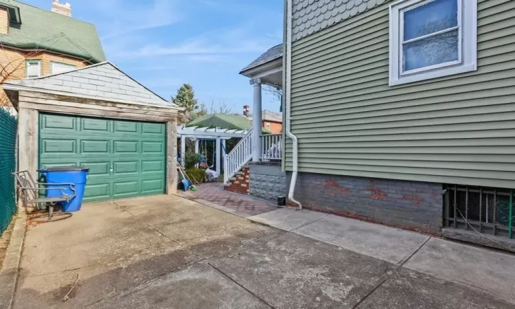 View of side of property featuring an outbuilding and a garage