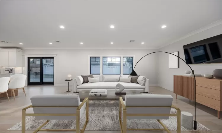 Living room with light hardwood / wood-style flooring and crown molding