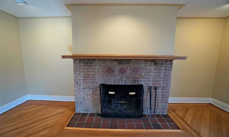 Living room with a chandelier, radiator heating unit, and wood-type flooring