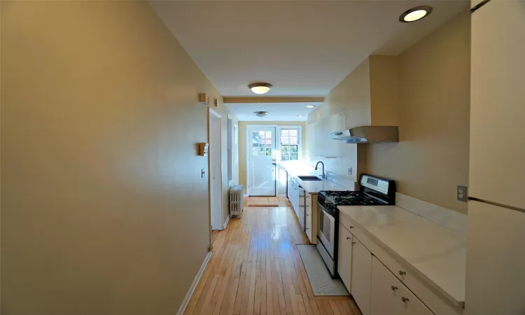 Dining room featuring a wealth of natural light, ornamental molding, and dark hardwood / wood-style flooring