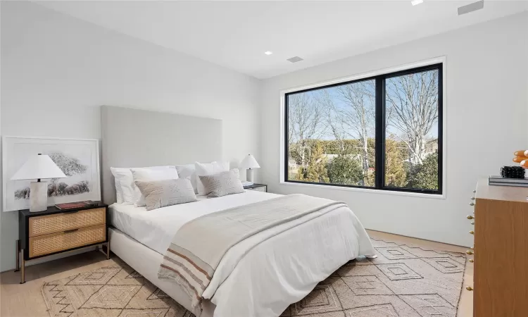 Bedroom with light hardwood / wood-style floors