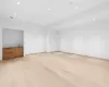 Unfurnished living room with light hardwood / wood-style flooring and sink