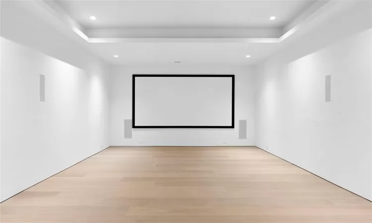 Home theater with light hardwood / wood-style flooring