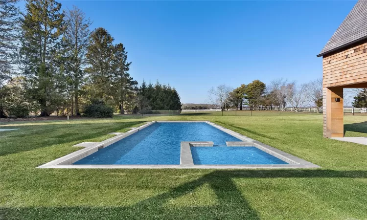 View of pool featuring a lawn