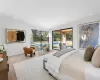 Bedroom featuring access to exterior, light hardwood / wood-style flooring, and crown molding