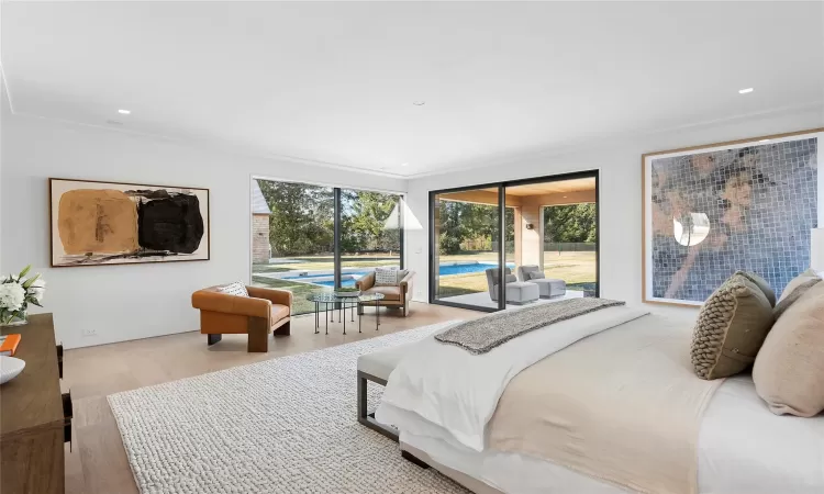 Bedroom featuring access to exterior, light hardwood / wood-style flooring, and crown molding