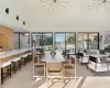 Dining room featuring high vaulted ceiling, sink, a notable chandelier, and light wood-type flooring