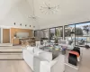 Living room featuring a chandelier, light hardwood / wood-style floors, and high vaulted ceiling