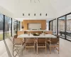 Dining area featuring high vaulted ceiling and light hardwood / wood-style flooring