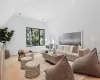 Living room featuring light wood-type flooring and vaulted ceiling