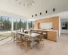 Dining space with a high ceiling and light hardwood / wood-style flooring