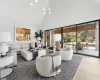 Living room with an inviting chandelier, dark hardwood / wood-style floors, and high vaulted ceiling