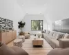 Living room with light hardwood / wood-style flooring and lofted ceiling