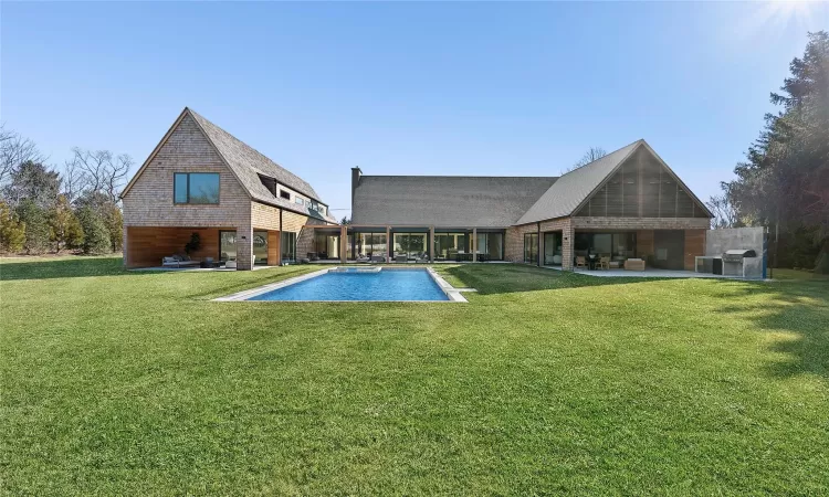 View of swimming pool featuring a lawn