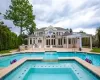 View of swimming pool with an in ground hot tub, a patio area, and an outdoor kitchen