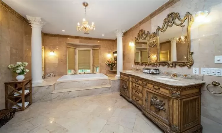 Bedroom with a notable chandelier, hardwood / wood-style flooring, ornamental molding, and a tray ceiling