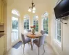 Kitchen featuring pendant lighting, a kitchen island, wine cooler, light stone counters, and a breakfast bar area