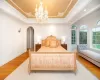 Hallway with crown molding, light tile patterned flooring, a chandelier, and french doors