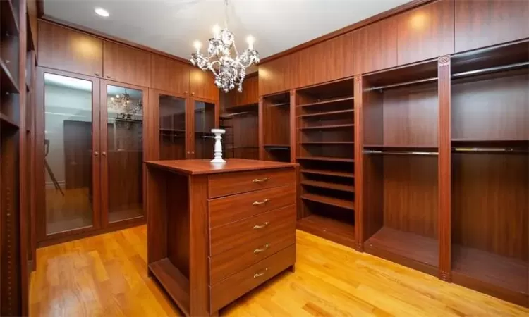 Bedroom with crown molding, light hardwood / wood-style floors, access to exterior, and a tray ceiling