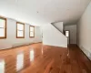 Unfurnished room featuring a baseboard heating unit and hardwood / wood-style floors