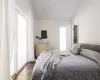 Bedroom featuring access to outside, dark wood-type flooring, and lofted ceiling