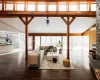 Living room with ceiling fan, wood-type flooring, and high vaulted ceiling