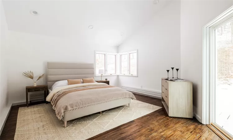 Bedroom featuring high vaulted ceiling, a baseboard heating unit, and dark hardwood / wood-style flooring